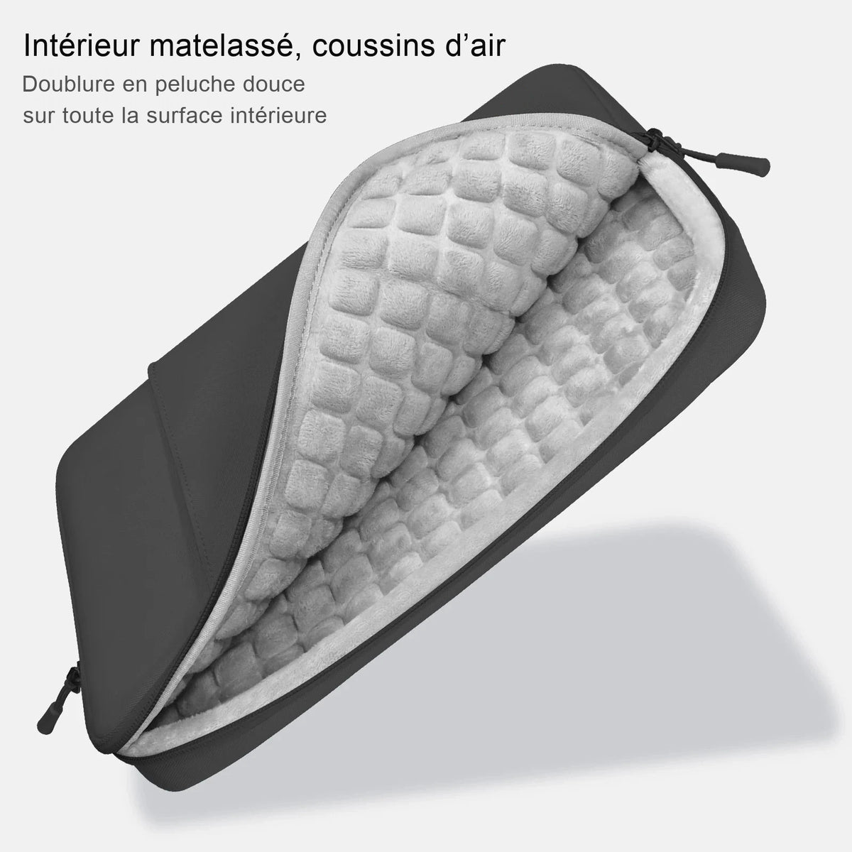 Housse d'ordinateur en néoprène gris foncé, ouverte, montrant sa doublure matelassée en peluche claire.